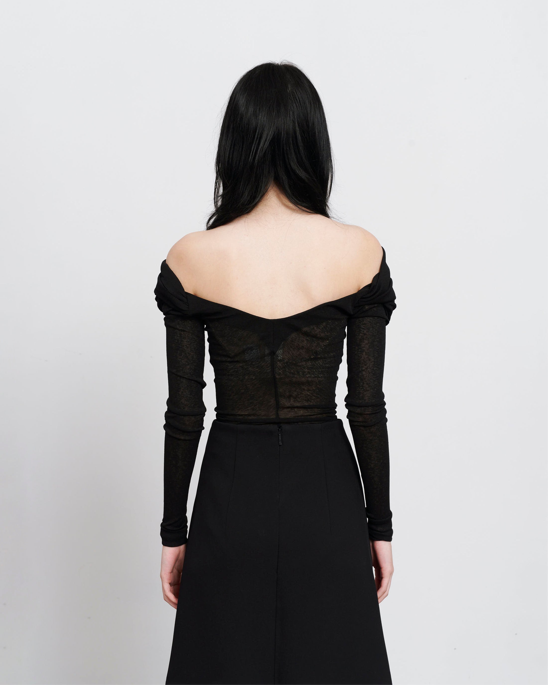 Back image of The Ada off the shoulder top in black. A semi sheer rouched off the shoulder top